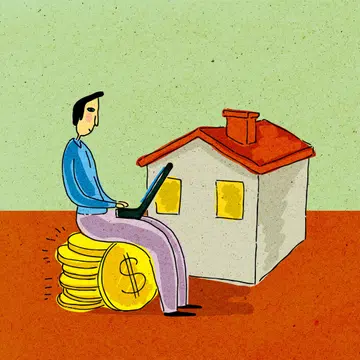 A man sitting on stack of dollar coins; working on laptop computer in front of house.