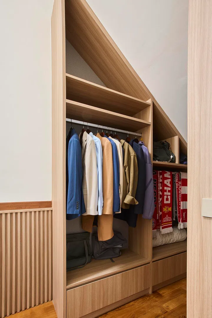 Custom shelving and hanging space are neatly integrated within the concealed nook.