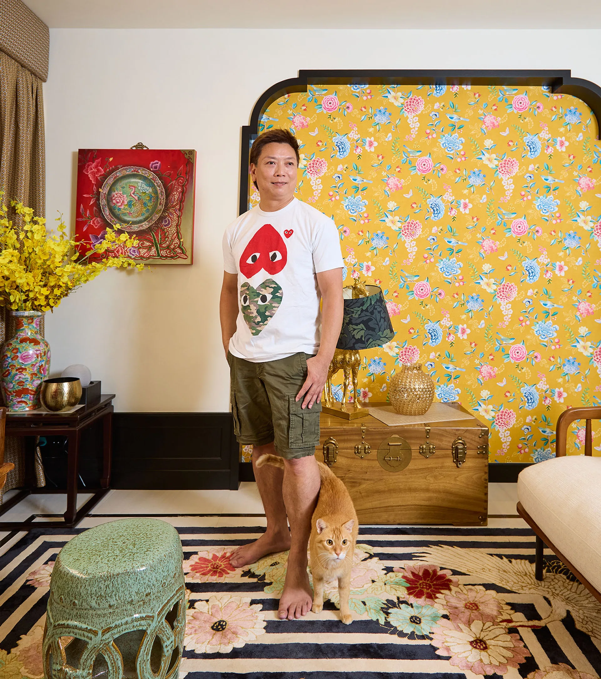 Homeowner, Mark Wong, who is in his 50s, poses for a photograph in his living room.