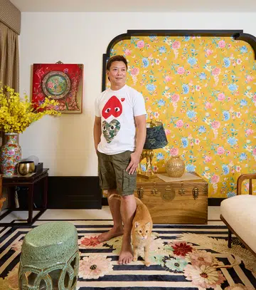Homeowner, Mark Wong, who is in his 50s, poses for a photograph in his living room.