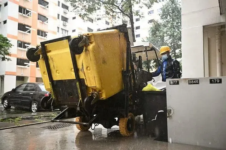 HDB Conservancy S&CC Fees increase. HDB Town Council rubbish chute truck emptying trash from HDB block