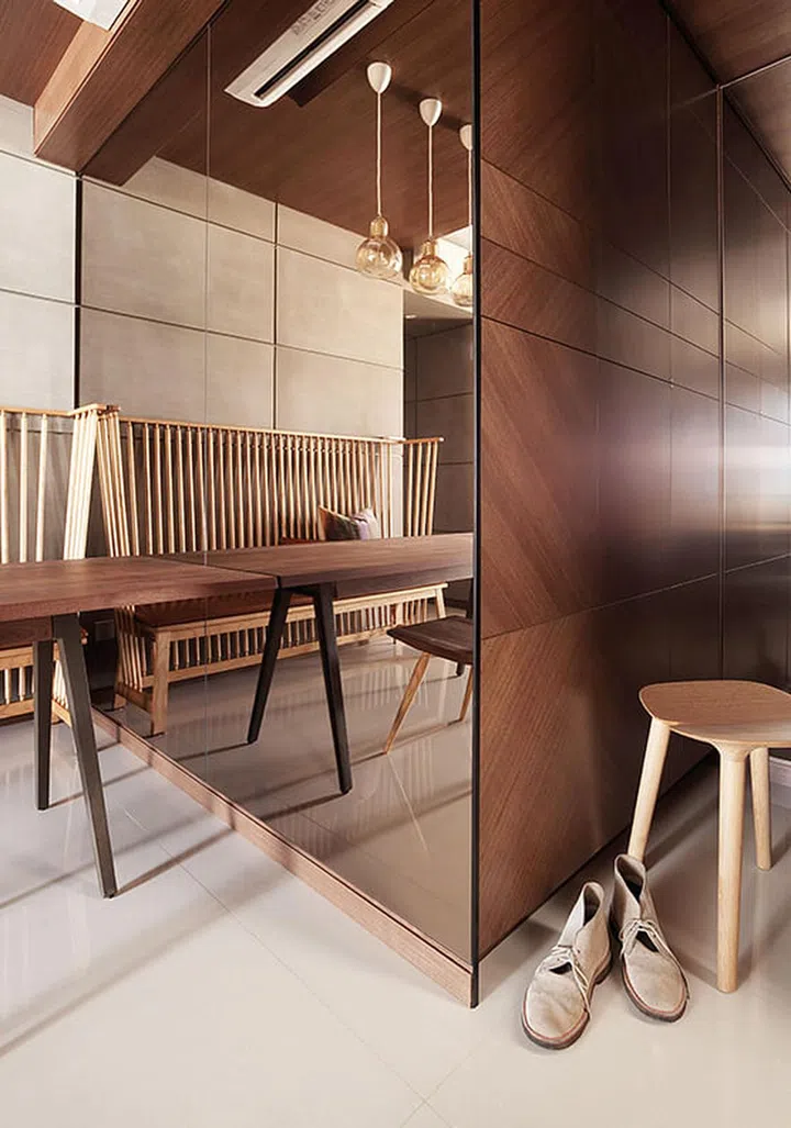A mirrored wall with a tea-tint gives the dining area a cosy air.