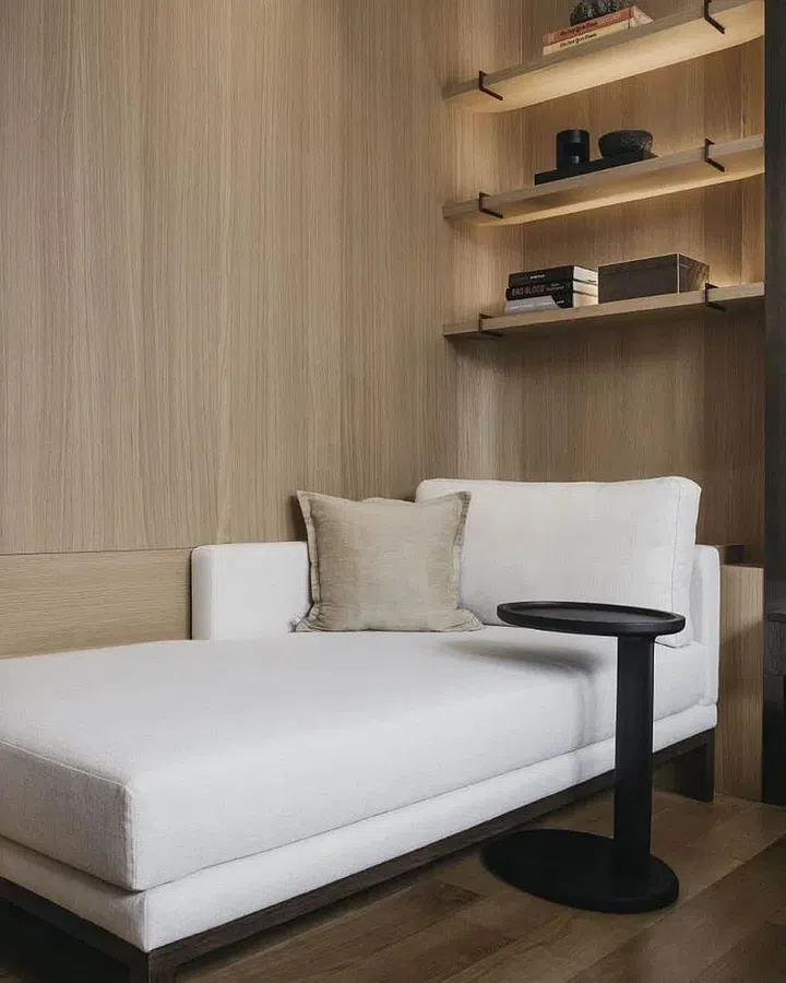 The master bedroom in this 8 Napier Road condominium also accommodates a daybed placed before shelves that can be lined with books. (Photo: Studio Periphery)