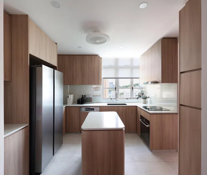 A movable island anchors the kitchen, where lightwood cabinetry and sliding glass doors strike a balance between openness and privacy.