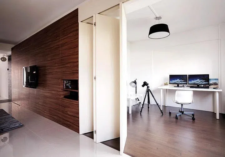 An accordion-type door offers some demarcation, separating the study from the living area. Opening the door also lets more sunlight in from the windows.