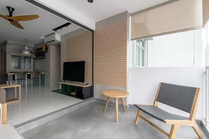 Concrete screed flooring span the balcony of this Modern Scandinavian-style HDB flat.