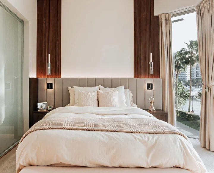 The emphasis on symmetry and vertical lines give the master bedroom a sense of luxury and airiness.