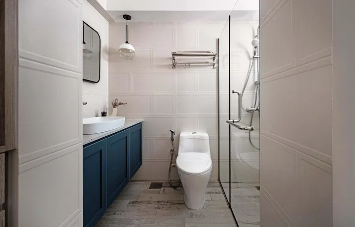 Bathroom with teal cabinets and wainscotting
