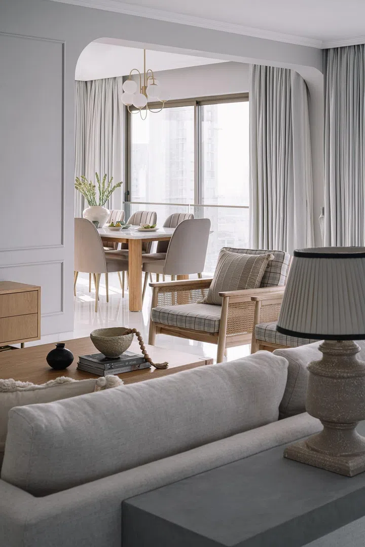 The living room is split into formal and informal zones in this 2-bedroom apartment in Parsi, Mumbai.