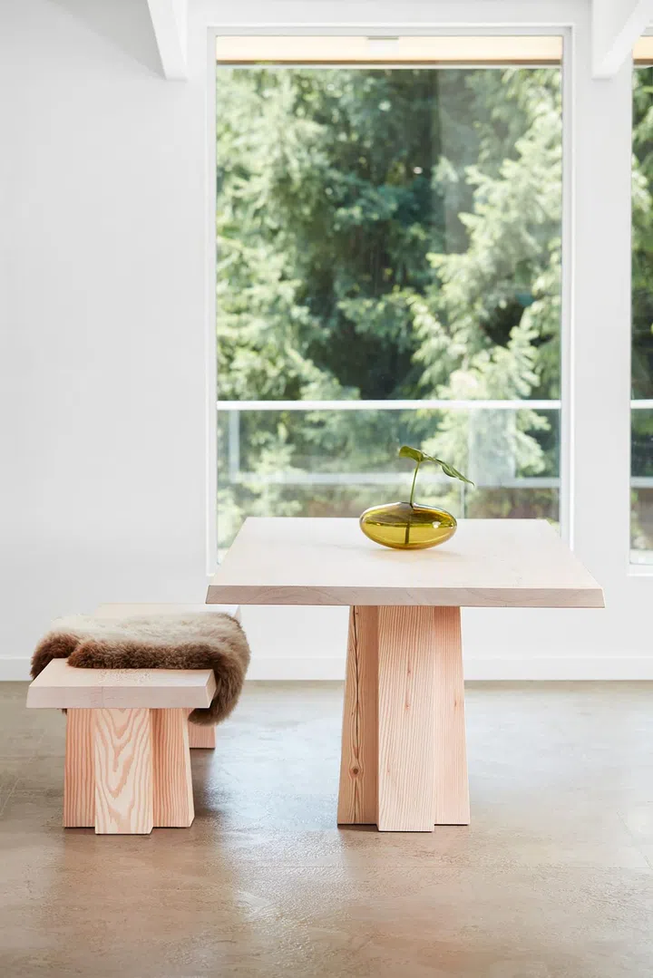 Solid wood bench and dining table in an all-white room. Design and Art direction by Brent Comber Originals. Photo by Courtesy of Brent Comber Originals