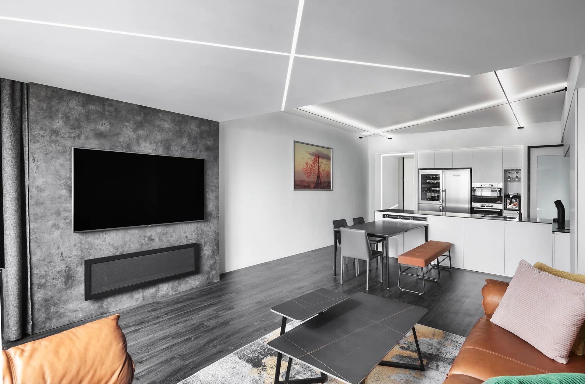 A reconfigured space defined by crisp monochrome finishes and bold LED ceiling strips—a design move Kelvin calls one of his favourite features.