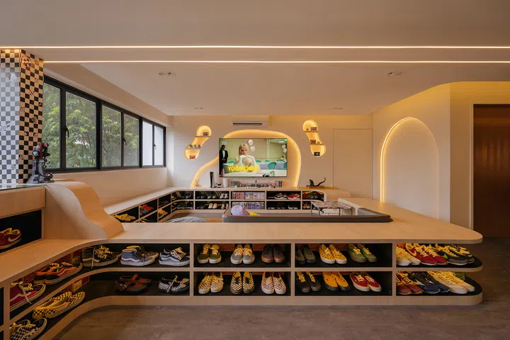 Integrated lighting turns the conversation pit into a glowing sneaker showcase after dark.