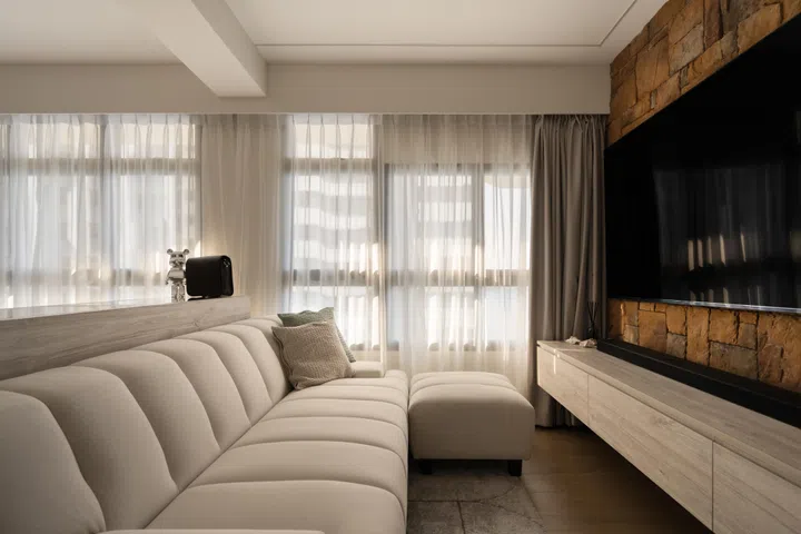 The low sofa and layered neutrals echo the home’s calm, nature-inspired palette, framing the view that Mr Lin enjoys each day.ack to top