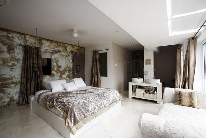 A palette of muted golds gives an understated, luxe look to the master bedroom and open bath.