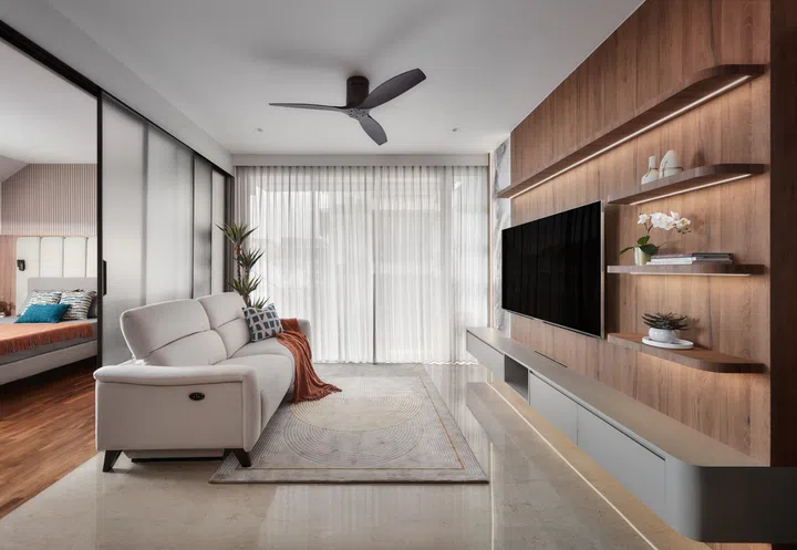 The living room is anchored by a recliner sofa and a textured feature wall, blending comfort with understated elegance.