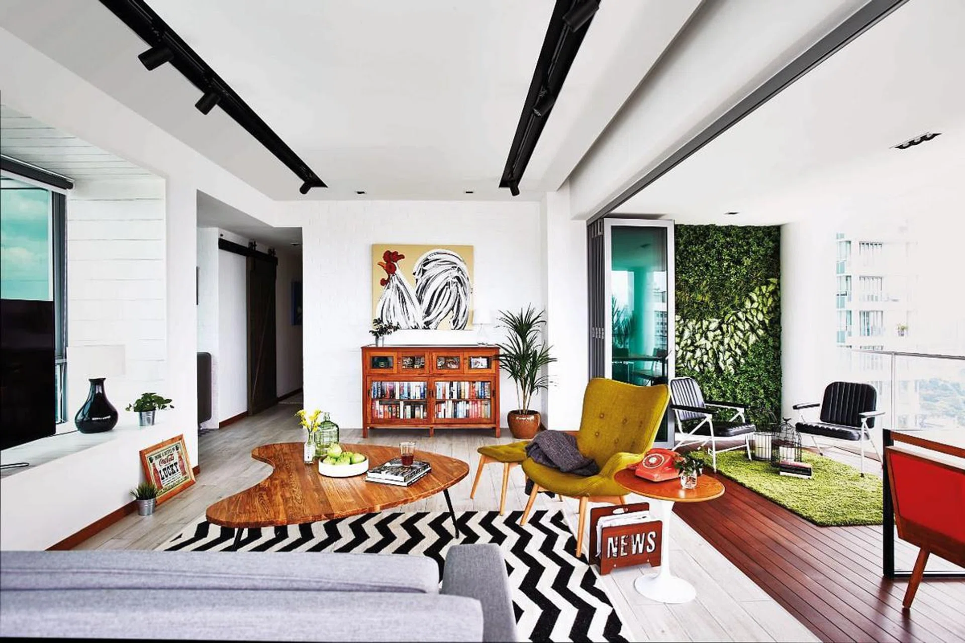 Living room of 3-bedroom condominium unit in Novena is adorned in a mixture of styles, from vintage to Scandinavian. Interior design by Museum Homes.