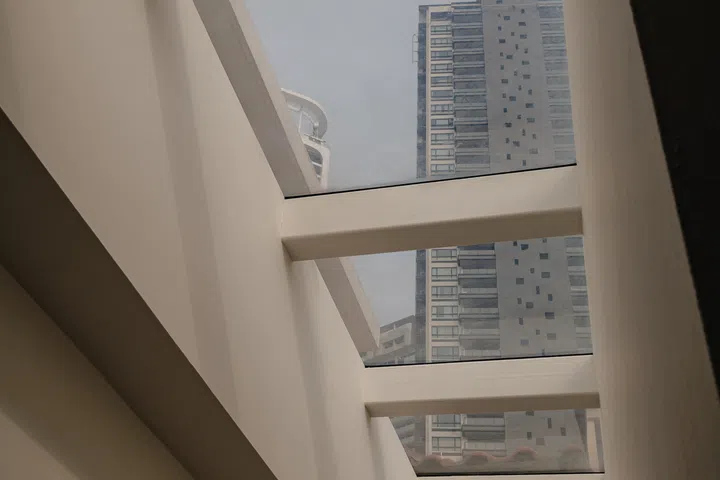 A row of skylights draw daylight deep into the long shophouse and illuminates the room corridor on the second floor.