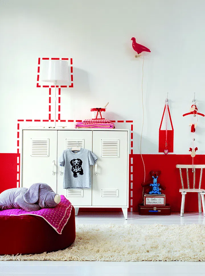 Half-height red wall paint with matching red design decals in a children's bedroom. Image by Akzo Nobel.