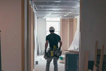 Back view of a professional renovation team working on interior home improvements