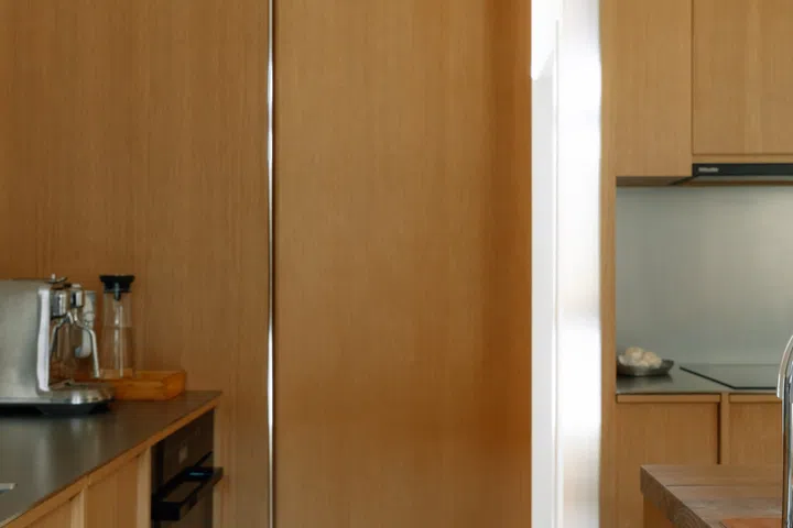 Even the concealed kitchen door incorporates a discreet cat flap, allowing Yquem and Lafite to roam freely throughout the home.