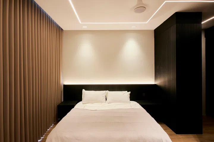 Concealed LED lines trace the ceiling and headboard, providing ambient light without visual clutter.