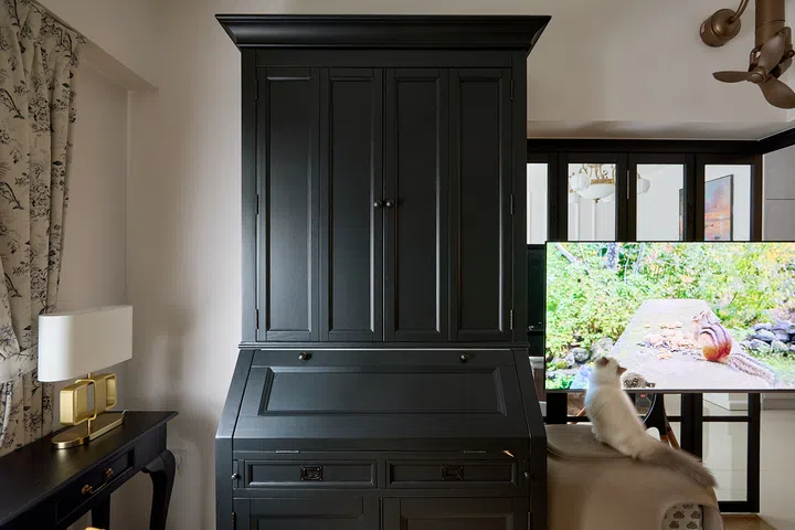The vintage-style secretary desk now shares the study with Mio, the couple’s Ragdoll kitten.