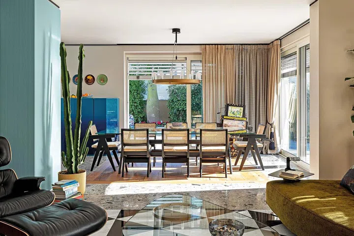 Capitol Complex table and chairs by Hommage à Pierre Jeanneret from Cassina. Chandelier by Fontana Arte.