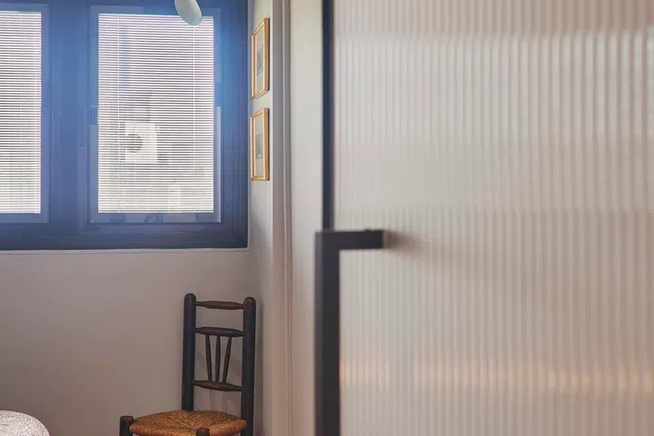 The fluted glass bedroom doors continue Ivan’s preferred “old school look”, adding texture and privacy without blocking light.