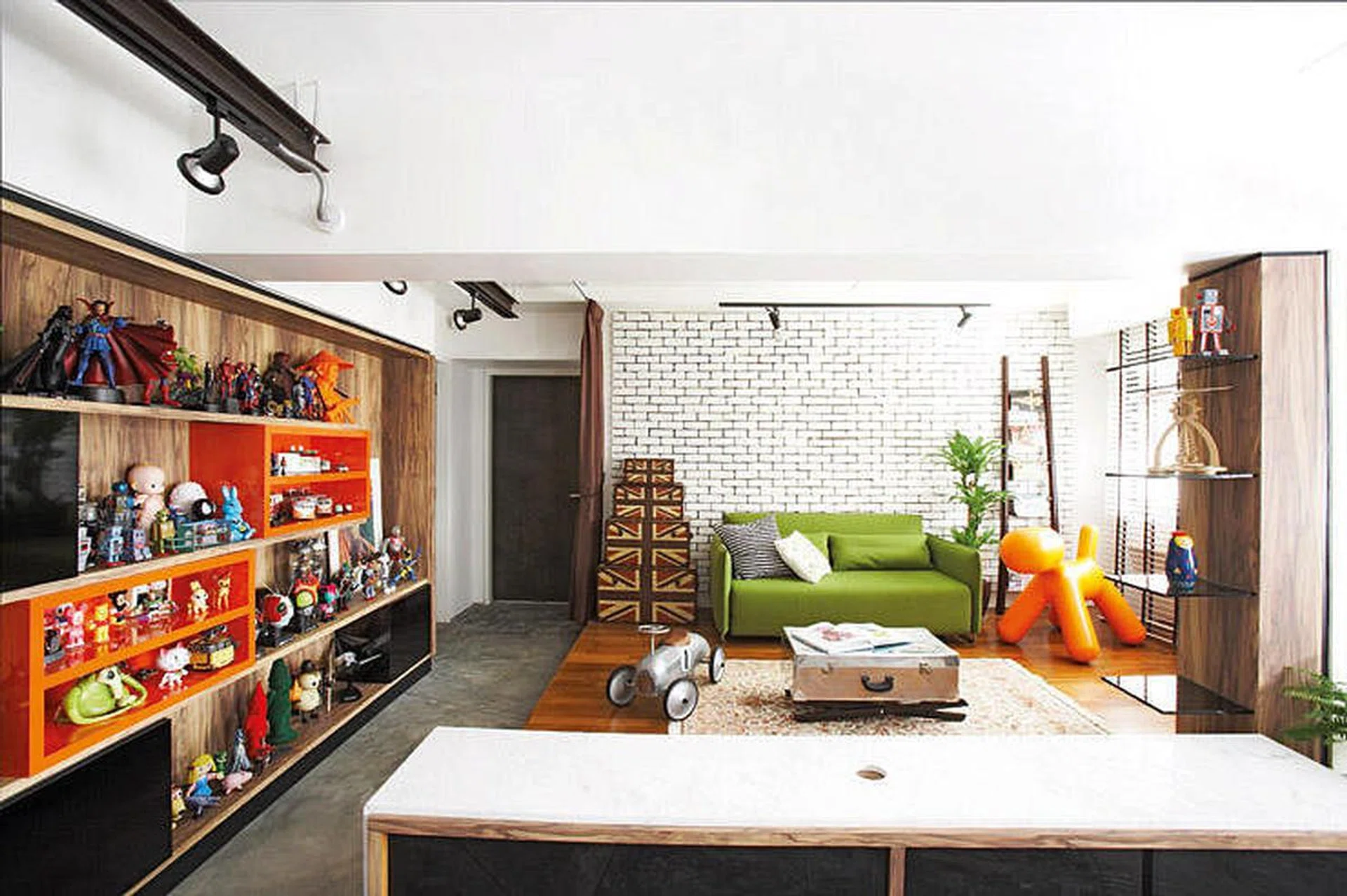 The home’s simple lines are enlivened by pops of colour in the form of toy figurines and statement pieces.