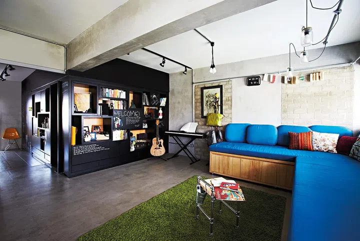 The master bedroom is separated from the common area by a partition, which also serves as a display shelf and doodle wall.