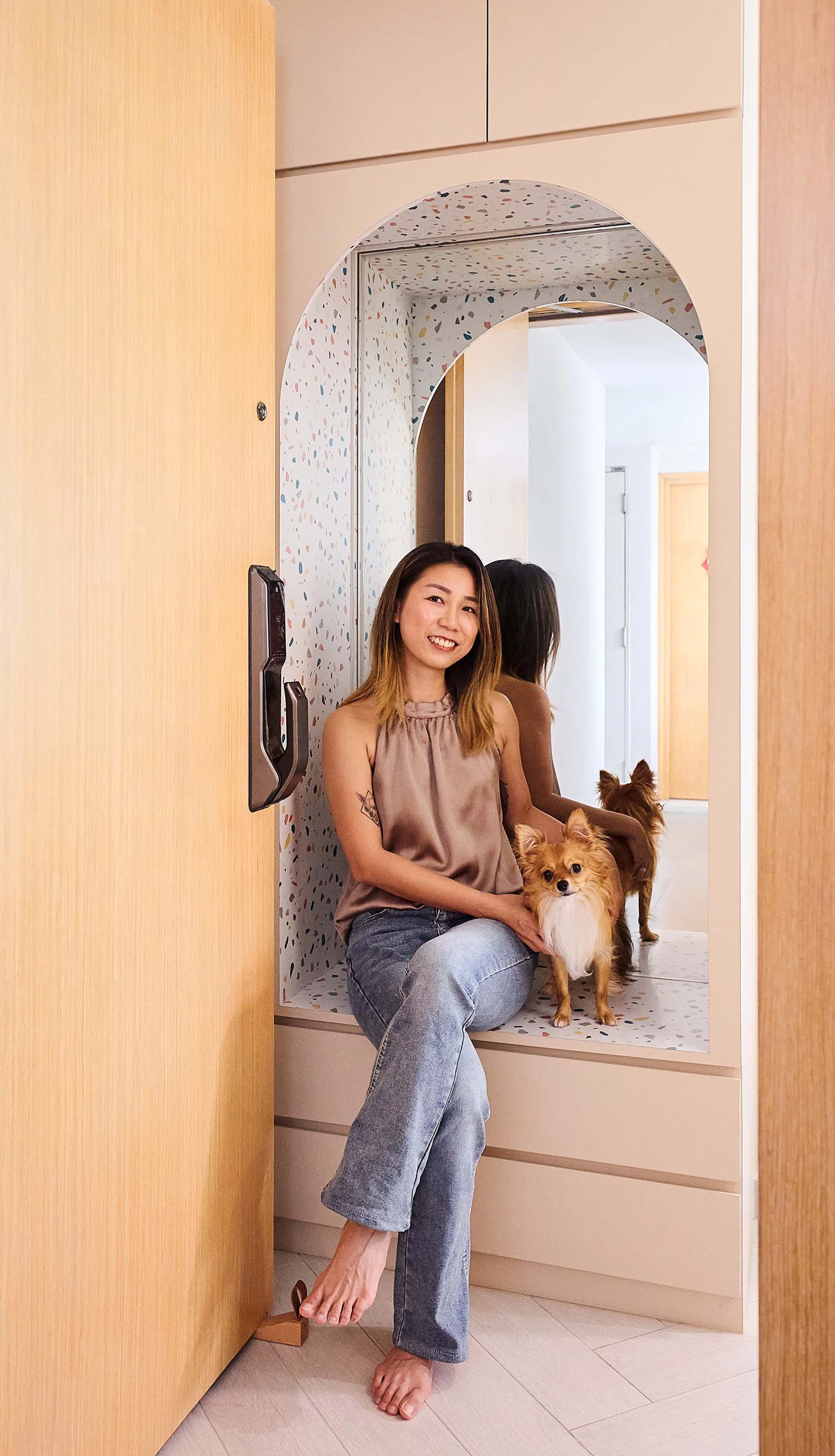 Eileen Teo, one of the homeowners, pictured with her chihuahua Peanuts, who was a key consideration in the pet-friendly design of the space.