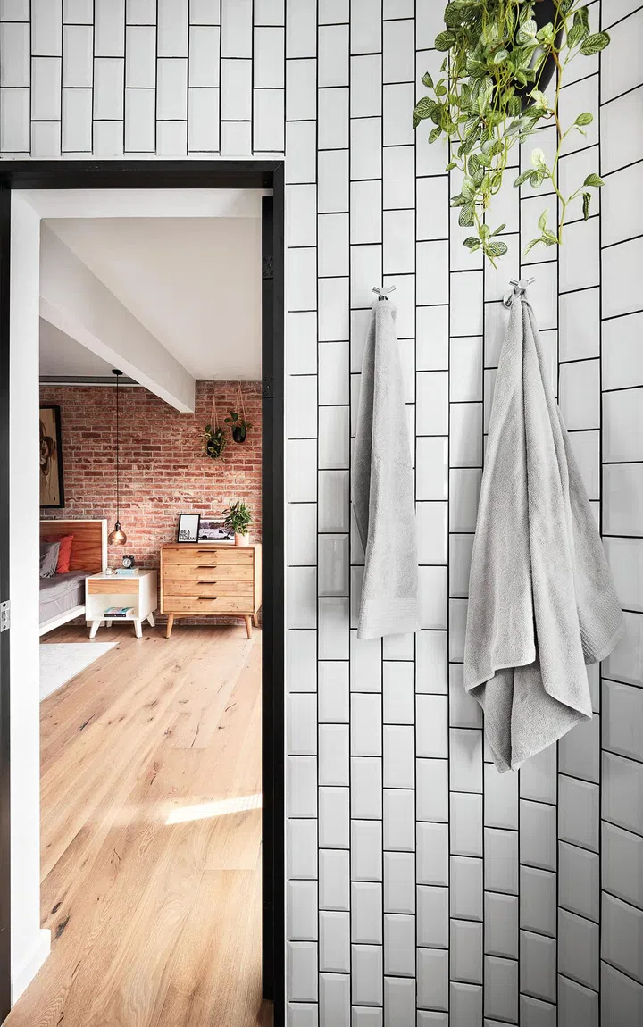 The black- framed doorways add a graphic touch that echoes the black-framed doors to the bedroom.