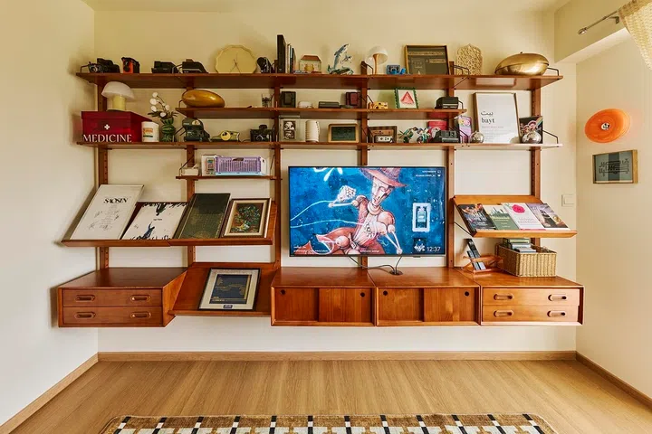 More than a TV feature wall, the display shelf showcases vintage cameras, vinyl records, books and treasured keepsakes collected together.