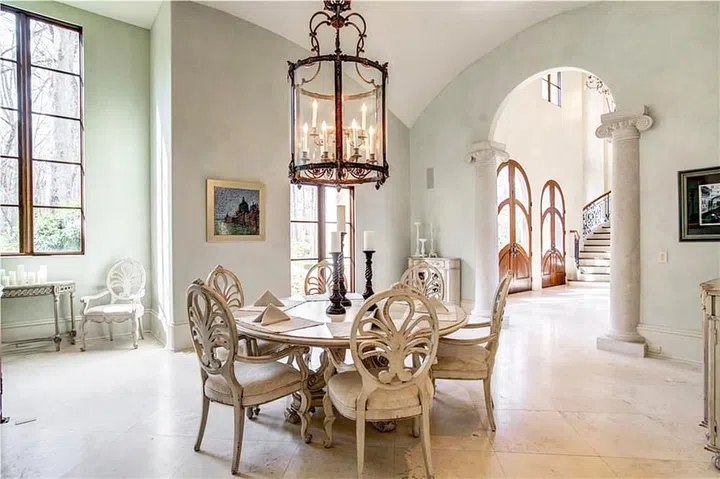 Cardi B's dining room features a small, round table, inspiring guests for a cosy, warm get together. Image by Zillow
