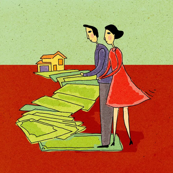 Couple walking along a path of money leading to a house.