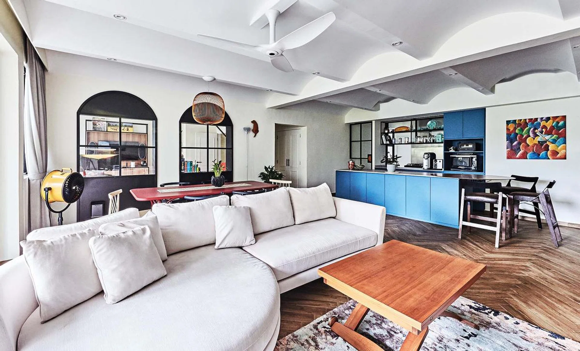 The seamless living, dining and kitchen area is softened by curvy elements, including the false ceiling that pays tribute to the building’s architecture.