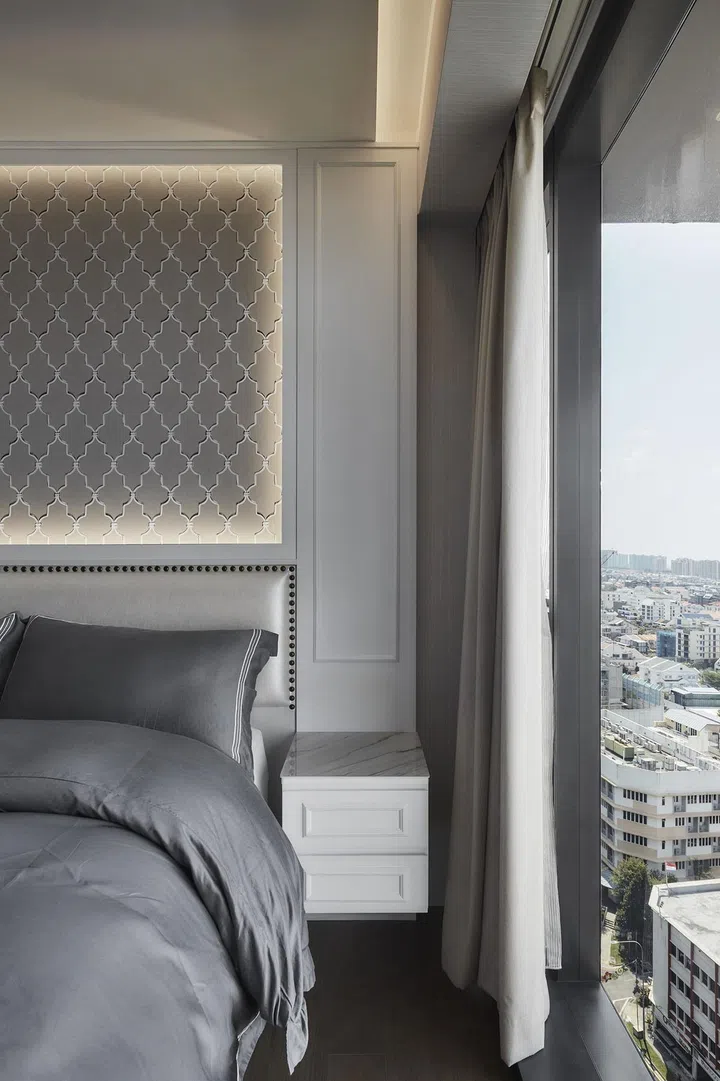 The master bed is positioned next to a full-height glass window offering views of the neighbourhood.