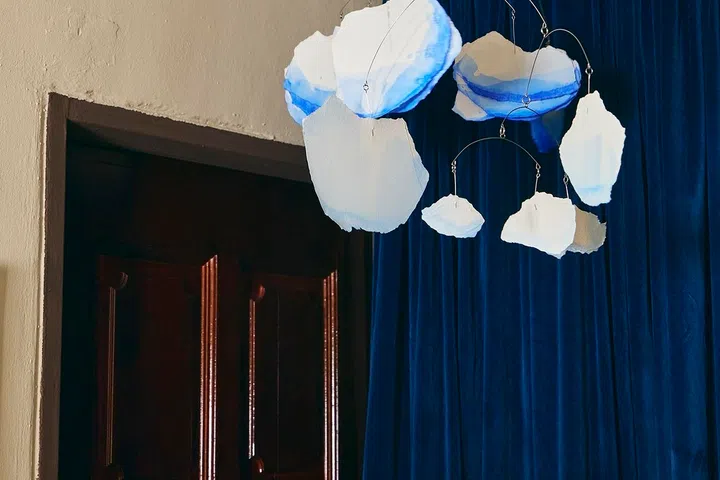 Painted paper clouds by an artist friend commemorate a past exhibition they created together.