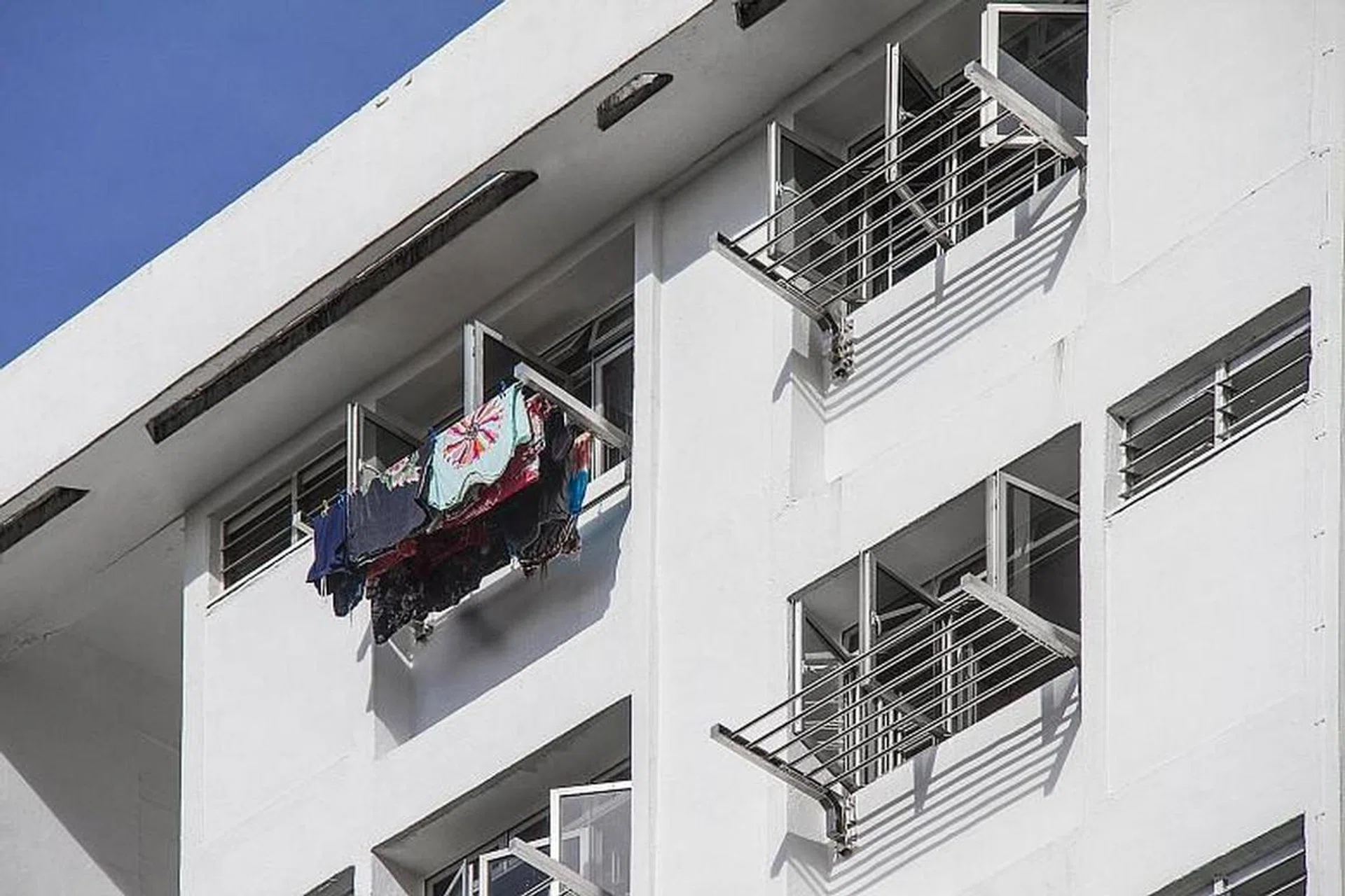 The new laundry rack comes with six horizontal stainless steel poles that can be extended and retracted within the frame of the rack. Residents would no longer need to manoeuvre heavy bamboo poles out of the kitchen window.PHOTO: HDB