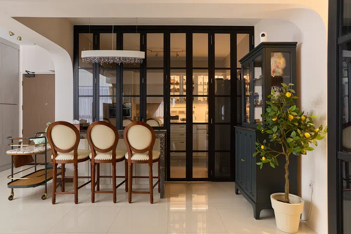 Black-framed bifold doors can completely close off the kitchen when needed.