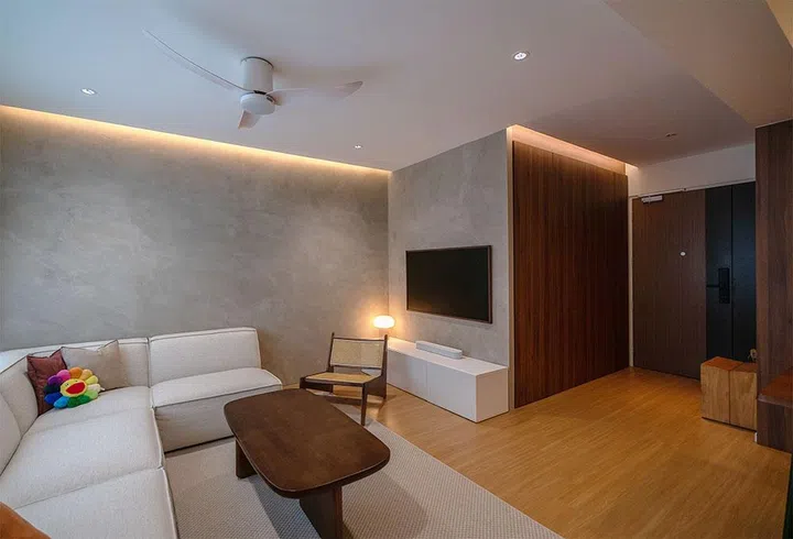 A wide view of the living room showcasing the 3.2-metre L-shaped sofa, positioned to face the windows for optimal layout and minimal glare.