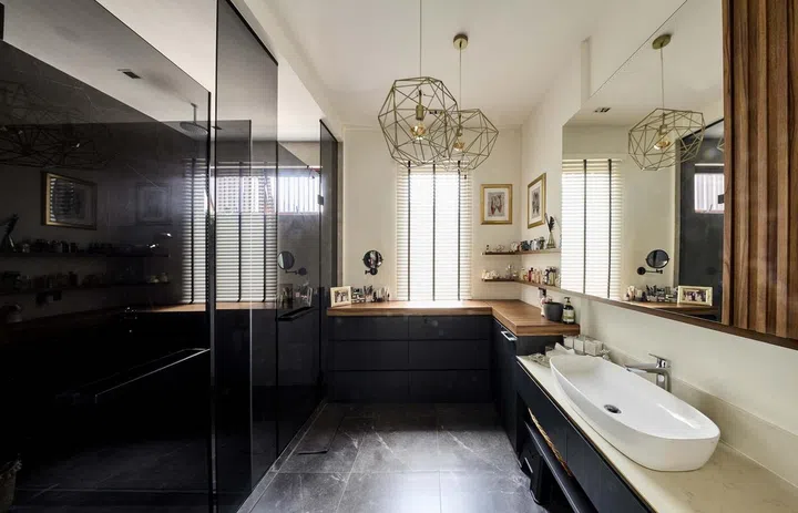 The changing area of a bathroom with drawers housing towels, clothes and undergarments in interior designer Cheryl Gay of Coterie Design's 3,600 sq ft semi-detached home in Yio Chu Kang.
