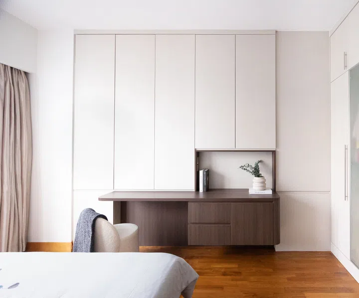 A tidy study sits in front of the bed in the master bedroom. Here is where the homeowner gets ready each morning.