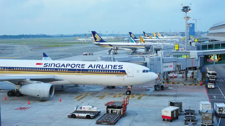 SINGAPORE - AUGUST 07: Row of Singapore Airlines, Tiger Air and Silkair aircraft parked at Changi Airport on August 07, 2015 in Singapore
