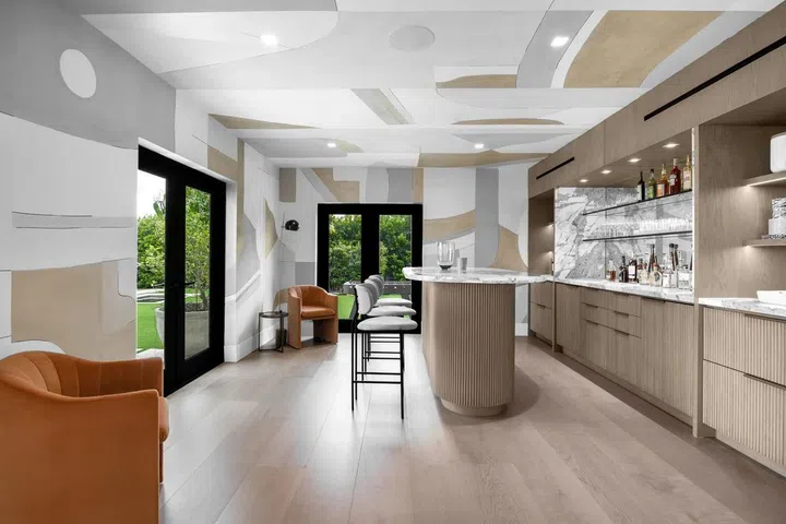A full home bar features marble countertops.