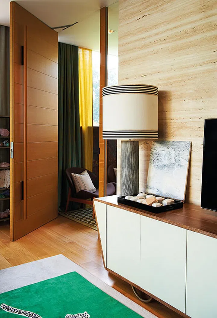 The sides of the wood and white lacquered cabinet are angled inwards, making it look less boxy.