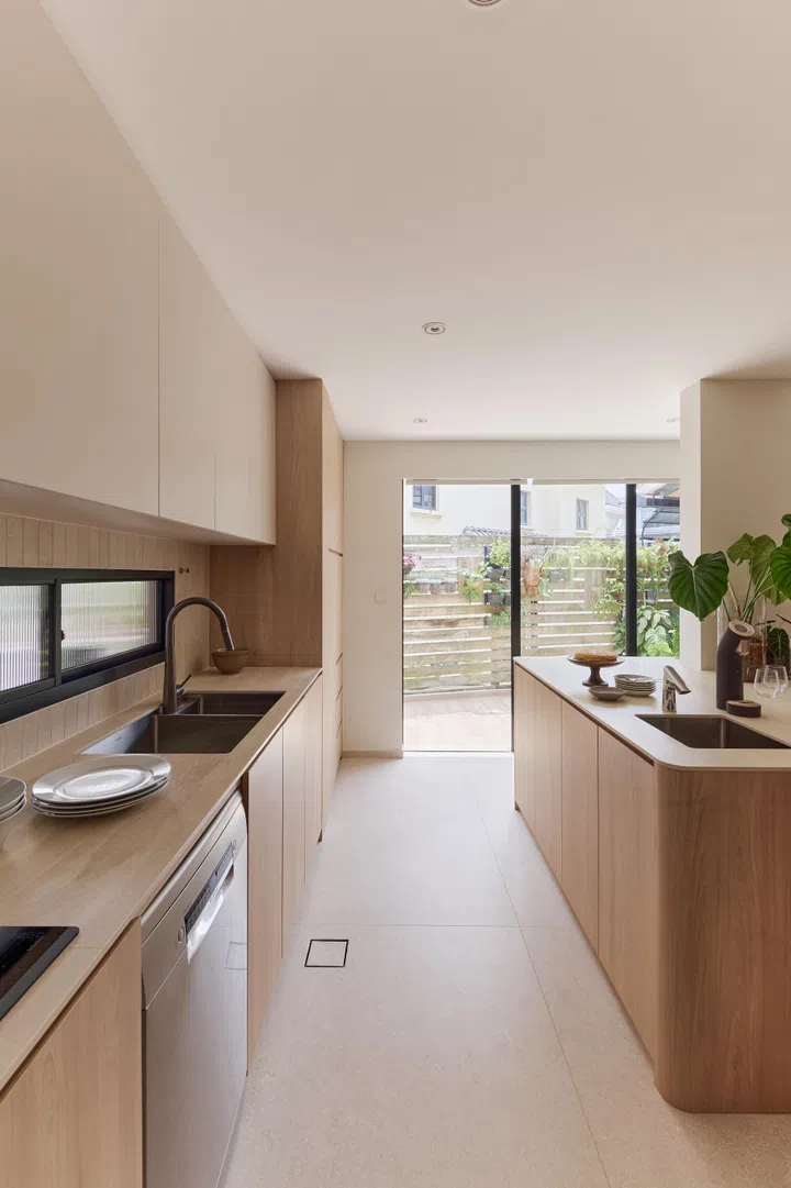 A generous island transforms the kitchen into the family’s favourite gathering place, equally suited to baking sessions, casual meals and weekend entertaining.
