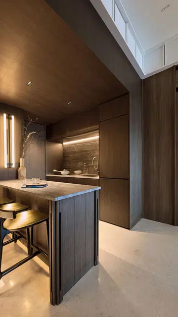 A hidden door in the dry kitchen of this 840 sq ft 2-bedroom condominium at Hillview Rise leads to a loft level guest room.