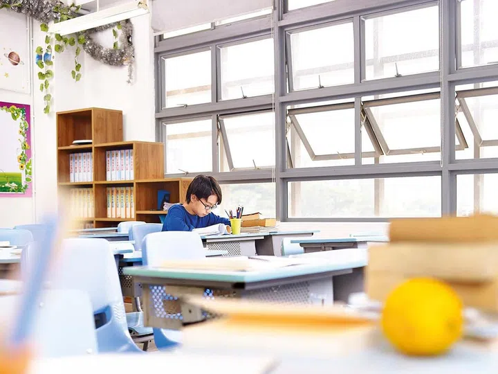 asian school boy studying alone in classroom.