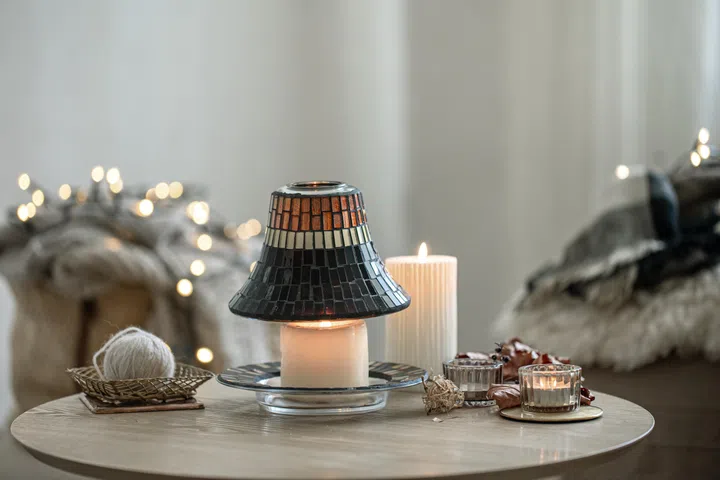 Beautiful candles in the Scandinavian style on a blurred background of the interior.